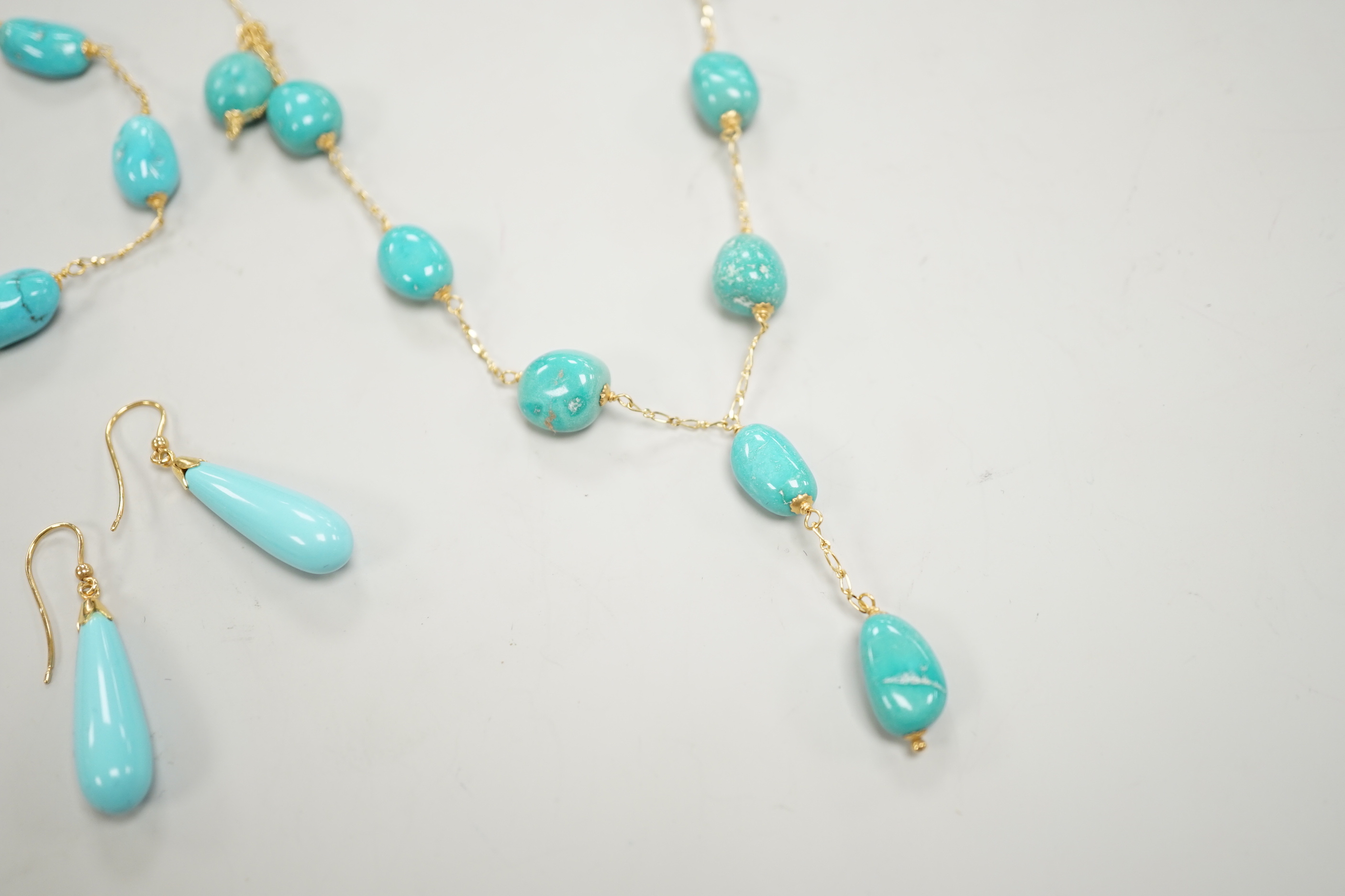 A modern Italian 750 and turquoise bead set necklace and matching bracelet, (necklace knotted) and a pair of similar enamelled? earrings, gross weight 29.4 grams.